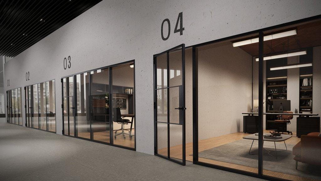 Glass and gypsum office partition dividing a workspace in Abu Dhabi
